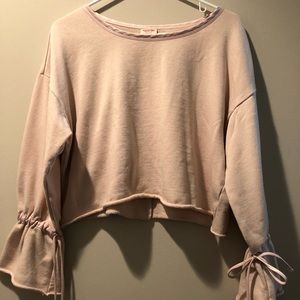 Light pink cropped sweater with bells leaves